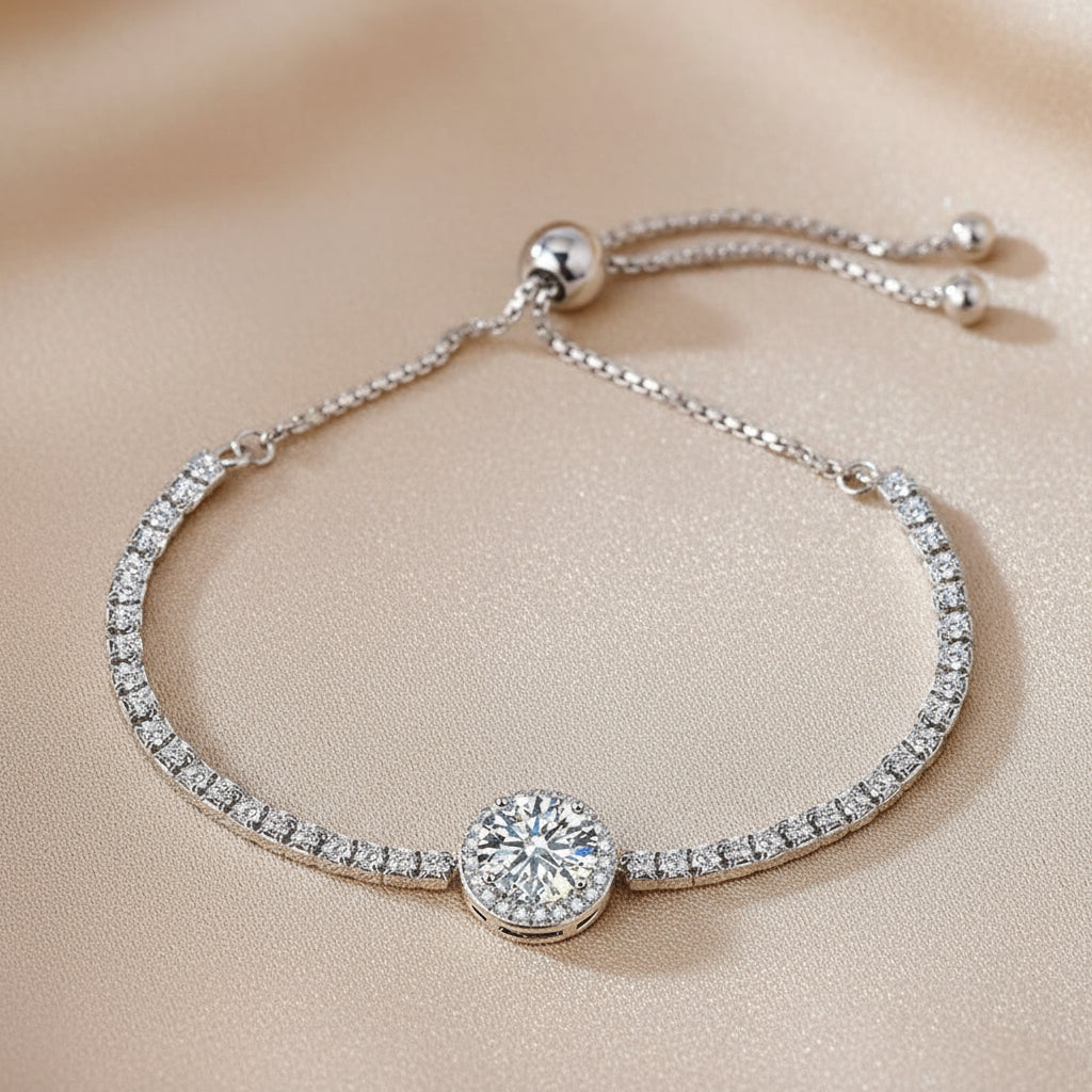 Silver bracelet with a round diamond-like stone on a blue textured background