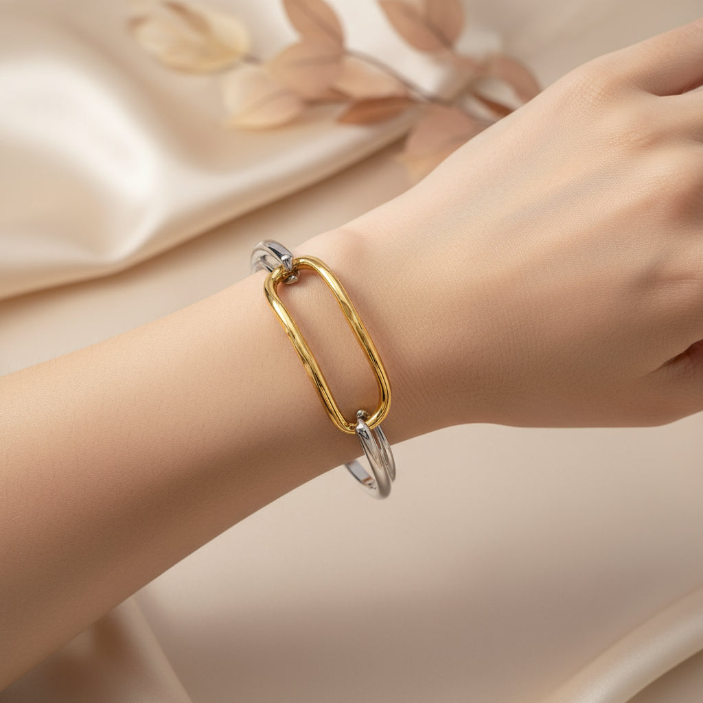 Two-toned silver and gold bracelet on a white background